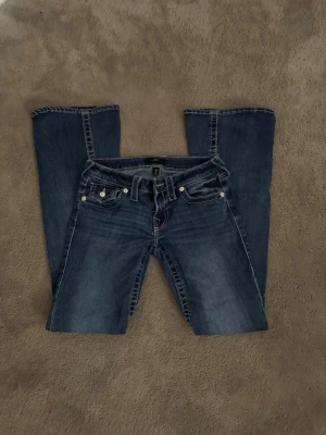 Blå bootcut jeans från True Religion - Säljer ett par blå bootcut jeans från True Religion i storlek 25. Inga hål, slitningar eller fläckar alls. 