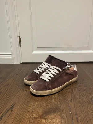 Vinröda mockasneakers med vita snören - Vinröda saint Laurent skor i storlek 42 i använt skick men har absolut kvar att ge