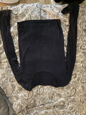 Marinblå långärmad topp med slits - Snygg marinblå långärmad topp med slitsdetalj vid ärmsluten. Tunn och mjuk i materialet, perfekt att styla till olika outfits. Enkel och stilren design som passar till mycket.