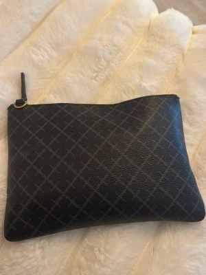 Säljer by Malene Birger väska - Säljer min svarta by Malene Birger väska. Den är i fint skick men är lite sliten på dragkedjan den man drar i som jag visar i sista bilden men inget som syns tydligt. Inga andra hål, fläckar eller defekter. För mer frågor eller bilder skriv privat. Band och väska/påse följs med.