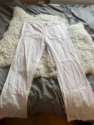 Rosarandiga lågmidjade pyjamasbyxor vintage H&M - Galet snygga lågmidjade pyjamasbyxor från Vintage H&M🪽 Har både knappar och snöre i midjan och en ficka bak. 100% bomull. I storlek S💗Jag skickar snabbt, som snabbast med instabox!
