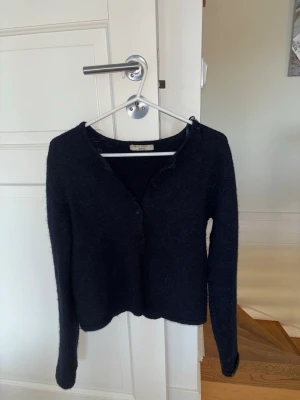 Svart kofta från Gina Tricot - Mysig svart kofta från Gina Tricot i borstat material. Koftan har v-ringning, knäppning framtill och långa ärmar. Enkel och stilren design som passar perfekt till lager på lager under kyliga dagar. skitsnygg, kom gärna med vin och frågor ❤️