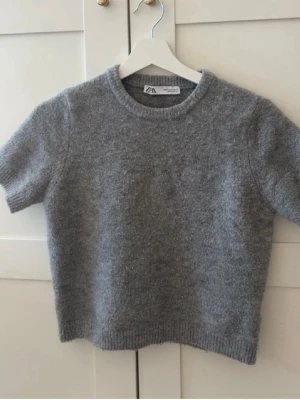 Grå stickad t-shirt från Zara - Kortärmad stickad t-shirt från Zara i storlek S.