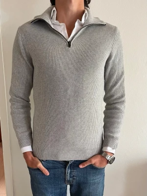 John Henric Kashmir-blanding zip  - Säljer denna feta ljusgråa quarterzip från John Henric. Det är en Kashmirblanding med bomull. Storlek: M. Ursprunget pris: 1 199kr. Vårat pris: 499kr. Skick: 8,5/10. Observera att det finns en liten fläck vid vänster ärmel.