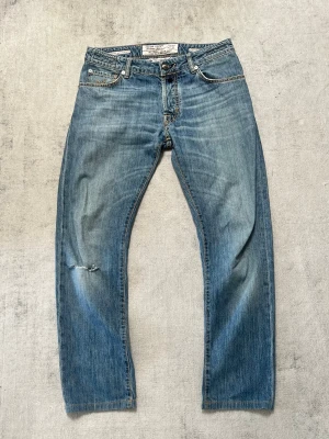 Jacob Cohën Jeans – Strl 33 - Säljer ett par äkta Jacob Cohën Jeans i storlek 33.  * Storlek: 33 * Färg: Ljusblå denim * Tillverkade i Italien * Bra skick med normalt slitage. * Hål vid vänster knä, se sista bilden.  Skickas väl emballerat eller hämtas enligt överenskommelse.  Vid frågor eller om du önskar fler bilder är det bara att skriva!