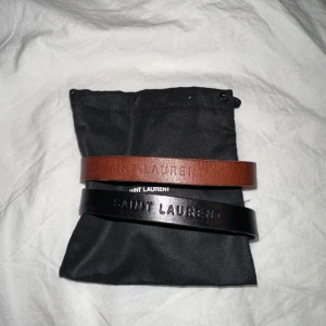 YSL Armband - Oanvända YSL armband, unisex! Ett brunt & ett svart, givetvis varsin dustag.  Kan köpas tillsammans alt var för sig! 🛑 Svarta sålt!  Givetsvis är dem äkta!!