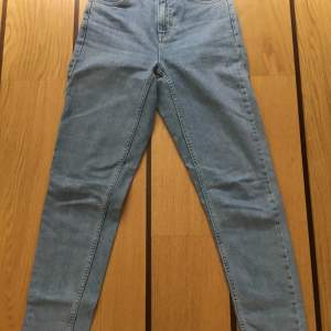 Ljusblå momjeans från Topshop. W26 (66 cm) L 34 (86 cm). 92% Bomull 8% Elastane (stretch). Hög midja, avsmalnande ben. Mycket bra skick!