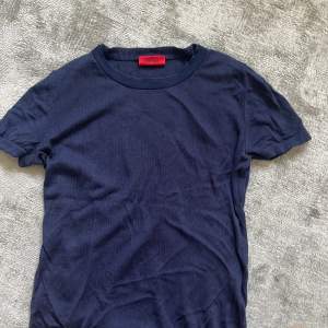 Stickad kortärmad tröja från hugo boss i marinblått, storlek small men passar även xs och m.
