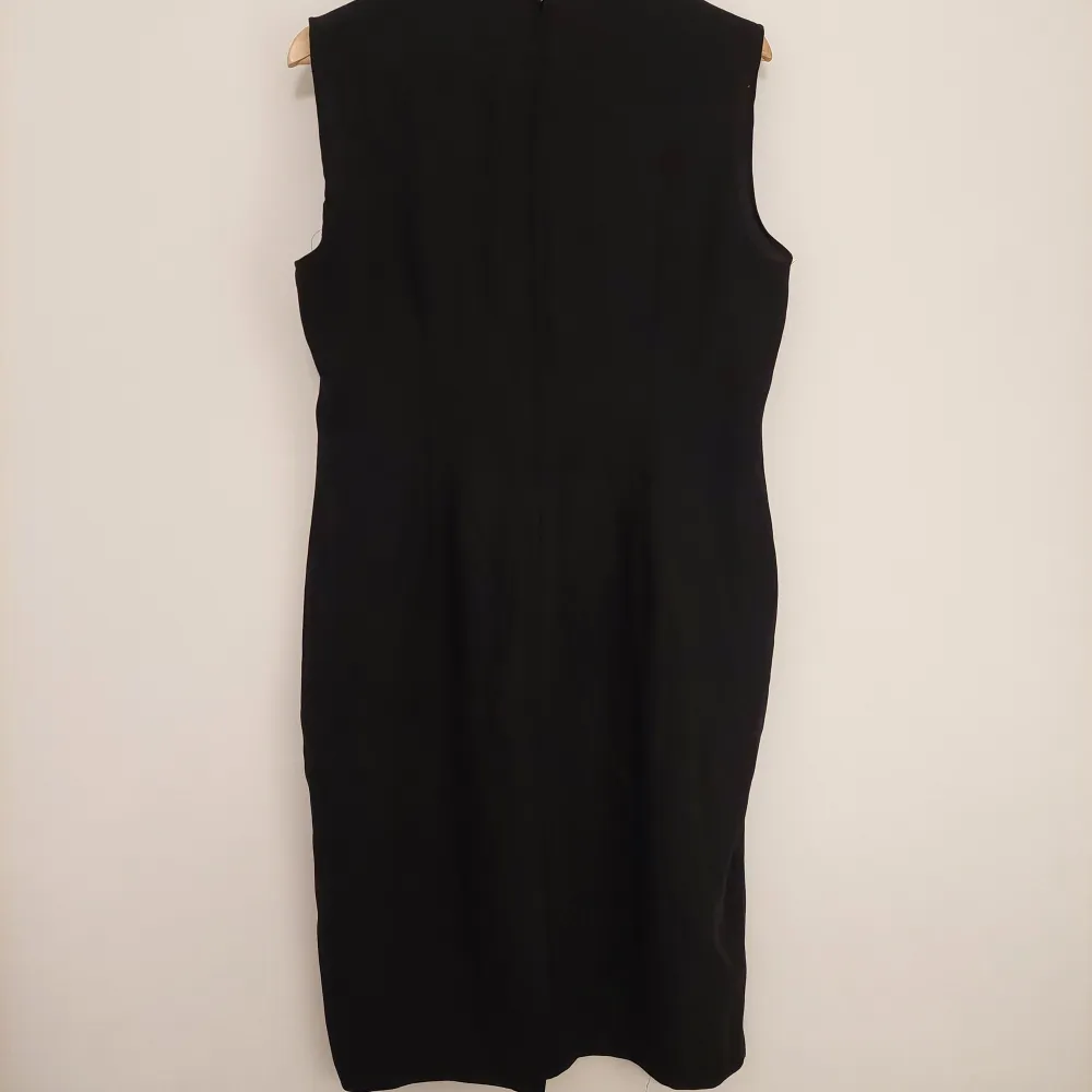 Lång svart klänning i tunnt material med dragkedja i bak. Är typ L. Klänningar.