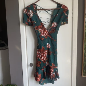 Blommig mörkgrön klänning - Den är från pretty little thing 