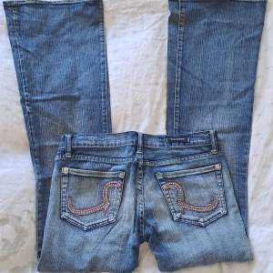Säljer ett par coola Rock & Republic jeans (storlek 28) i jättebra skick❤️‍🔥 Jeansen är lågmidjade och i bootcut-modell med supersnyggt bling på bakfickorna🌈🪩  Hör av dig vid intresse eller funderingar❤️ Använd gärna köp nu🫶
