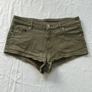 Lågmidjade jeansshorts - Säljer dessa ursnygga militärgröna lågmidjade jeansshorts från H&M!  Ganska korta i modellen, storlek 38. Bra skick och inga defekter