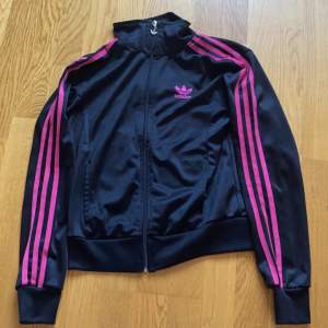 Säljer en svart adidas jacka med rosa ränder. Den har inga tydliga defekter och är i superbra skick 300kr fri frakt 