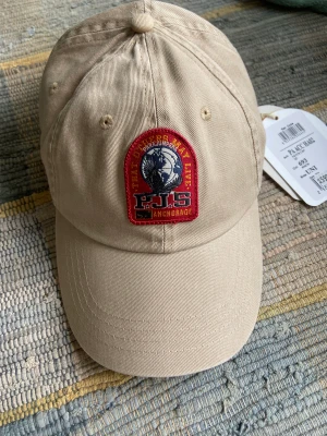 Parajumper keps - Helt ny keps parajumper med lappar på passade inte mig därför säljer jag. Org pris 600. Aldrig använd 