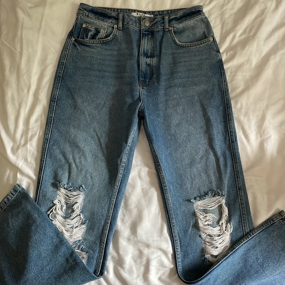 Jeans med slitningar på knäna från NA-KD i stl 40.. Jeans & Byxor.