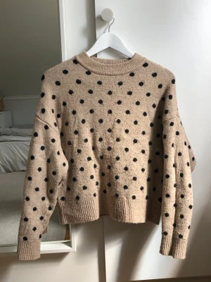 Stickad tröja med prickar - Beige stickad tröja med svarta prickar💕Den är lite nopprig men det är inget som märks. Priset kan diskuteras.