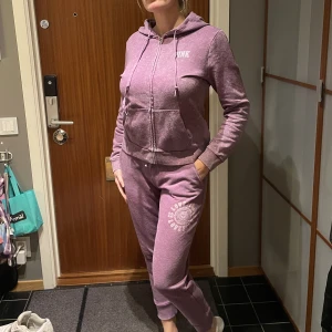 Victorias secret pink mjukisdress hoodie byxa lila - Mysig mjukis set med hoodie och byxor. Storlek M. Lila melerad i färgen. Bra begagnat skick lite små nopprig. Från djur o rökfritt hem. 