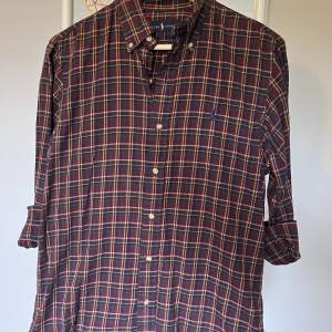 En Ralph Lauren skjorta med brun, röd, svart rut mönster