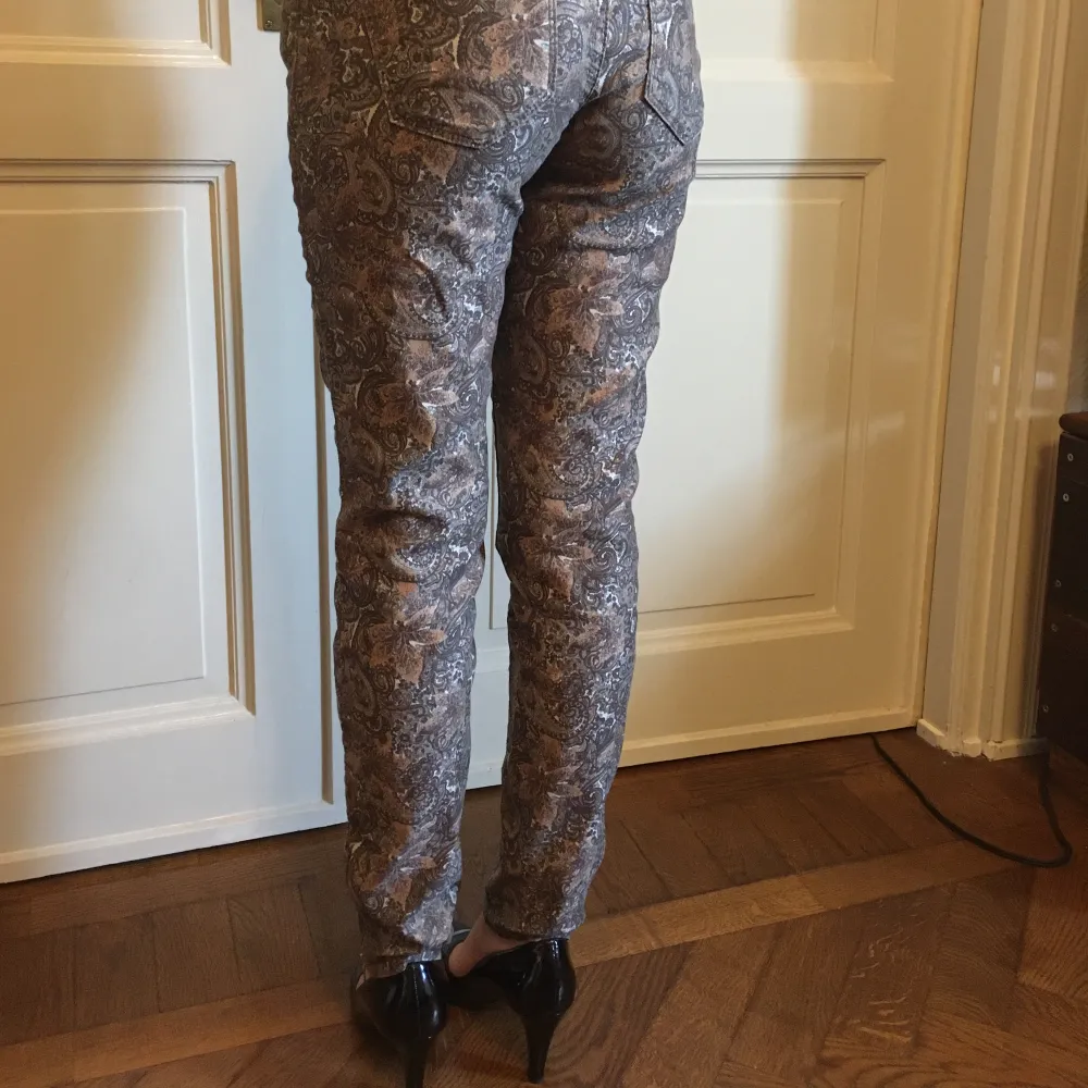 Mos Mosh Victoria Jive Pant - Metallic Choco Chip mönstrade byxor/jeans. Två framfickor, två bakfickor, dragkedja nere vid vristen, gulddetaljer. Midja är mellanväg.  Storlek: 27 Längd: 97 cm . Jeans & Byxor.