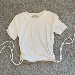 Fin t-shirt lite magtröja - En vit magtröja/t-shirt från ZARA i fint skick. Andvänt få gånger och ribbad på sidorna kolla på bilden. Säljer pga ingen andvändning💓.