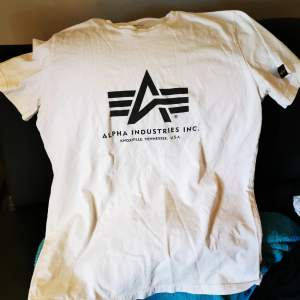 Vit Alpha Industries t-shirt i bra skick. 9/10. Använd men inga fläckar eller slitage. Storlek S. Digitalt kvitto finns.