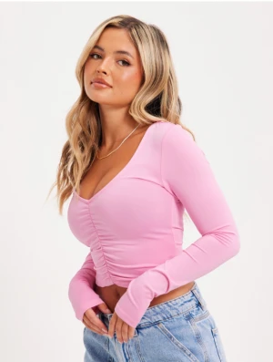 Nelly rosa rynkad topp - En rosa härlig tröja i svalt och skönt material i storlek s men passar xs-m pga mycket stretch.