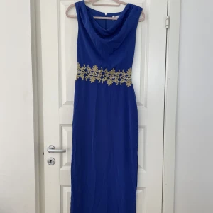 Klänning - Mörkblå aftonklänning med gulddetalj i midjan. Oanvänd. 
