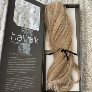 Hairtalk halo hairband 40 cm - Hairtalk hairband 40 cm, äkta hår- blandade färger för ett naturligt utseende, färgkoder 18/25/613. Använt två ggr, i superfint skick! Jag upplever färgen som något ljusare än bilderna.