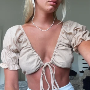 Beige topp - Beige topp med snöre från bikbok. Säljer även liknande i röd. 