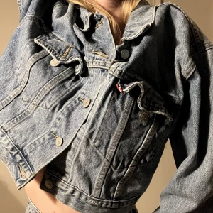 Levi jeansjacka  - Ljusblå jeansjacka från levi! Storlek L men jag (storlek xs/s) har använt den som en topp/croppad jacka. 