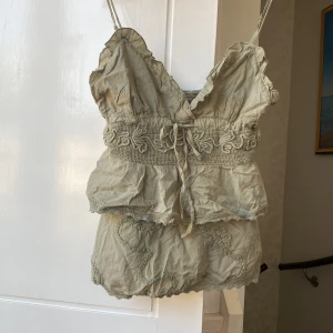 Volang topp - Jättesöt topp med fina detaljer. Kan regleras själv med knyte framtill och axelbanden. Helt ny med lapp kvar.  Ljusgrön/grå färg. Storlek M men passar XS-M! Köp görs via ”köp nu” knappen 🫶🏼