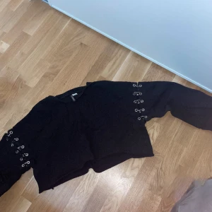 Cool tröja - Cool svart croppad, långarmad tröja med silver detaljer vid ärmarna. Vida armar. Älskar denna tröjan o den är använd en del men fortfarande i fint skick.