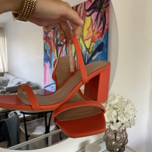 Orangea klackar - Orangea klackar i storlek 37. Klackhöjd 8cm. Aldrig använda utomhus. 🧡