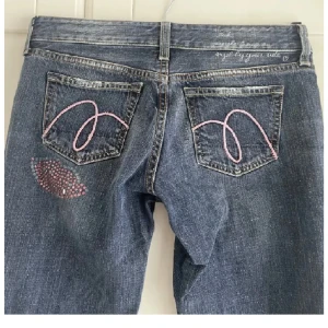 y2k flared jeans - Snygga jeans med mönster på fickorna! Mått: midja 35 cm platt, innerbenslängd 74 cm. Säljer då de inte passar mig. Skriv vid frågor eller flera bilder💗(lånade bilder i annonsen)