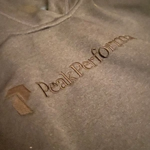 Hoddie  - Peakperformance Hoddie grå. Den är i nyskick. Storleken är M