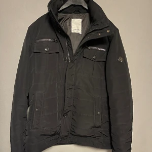 J.Lindeberg Jacka - J.Lindeberg jacka. Bra skick 8,5/10. Obs en knapp fattas. Nypris ca 3400 mitt pris 1450kr. Sitter bra på mig som är 183.