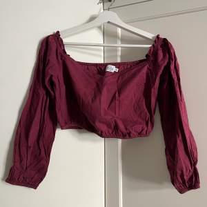 Wine red blouse with puffy sleeves, can be worn on or off shoulder. Used a few times, feels like new.