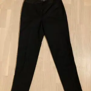 Brand new, never worn pair of classic black Esprit trousers with a satin detail at the top and slightly shimmering fabric. Perfect for a party night with a sprakly top and silver boots :) 