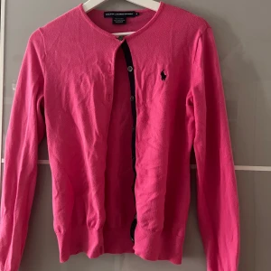 Rosa kofta från Ralph Lauren Sport - En rosa kofta från Ralph Lauren i storlek M (passar även S & Xs). Koftan är tillverkad av 100% Pima bomull och har långa ärmar. En av knapparna är lite trasig men ingenting som man lägger märke till💗