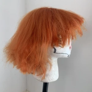 Orange short wig -  Choppy curled and short, recommend buying if you know what youre doing. Pretty thin very choppy