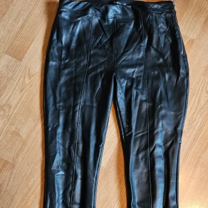 Tights - Byxor som är åtsittande med dragkedja på sidan. 