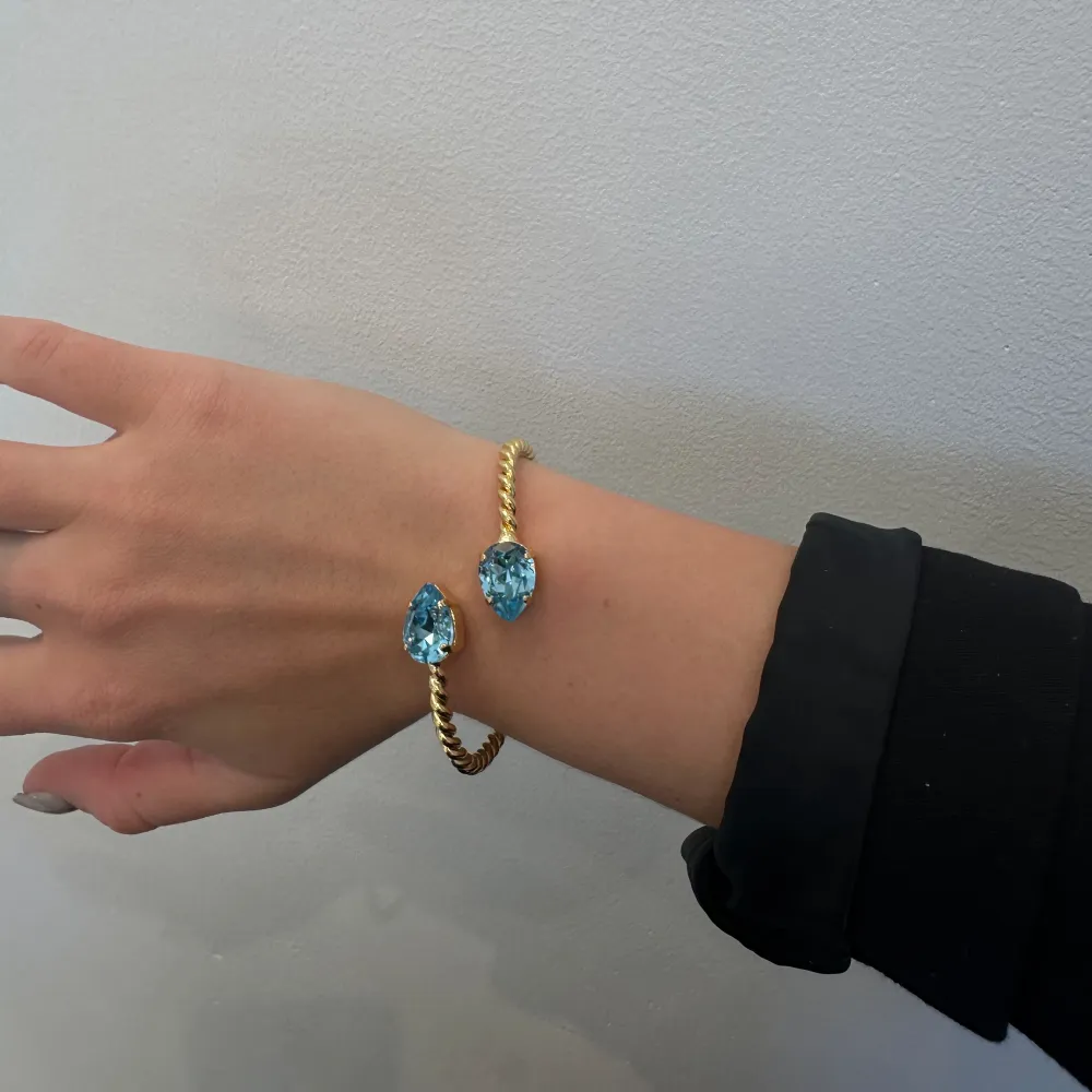 Säljer detta fina armband från Caroline Svedbom i färgen Aguamarine / Gold. Har inga defekter💛. Accessoarer.