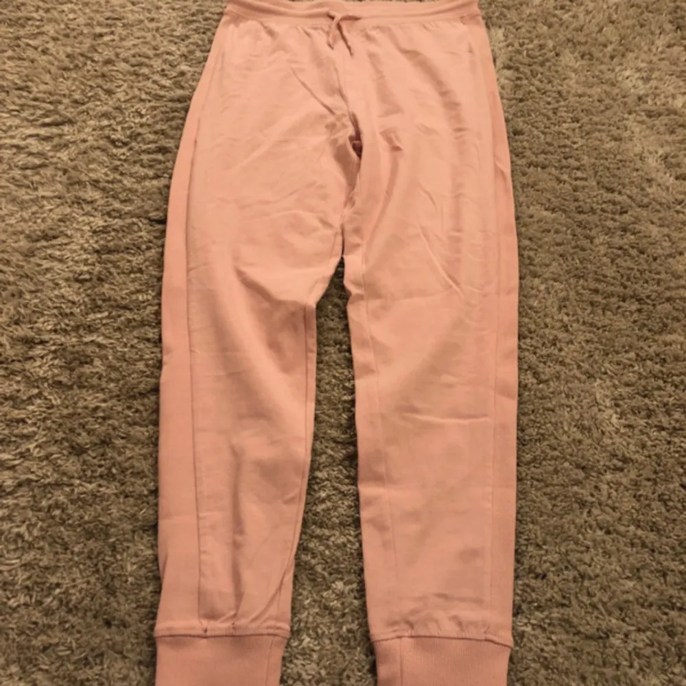 Pink pants and pink shirt with makeup inspired design . Jeans & Byxor.