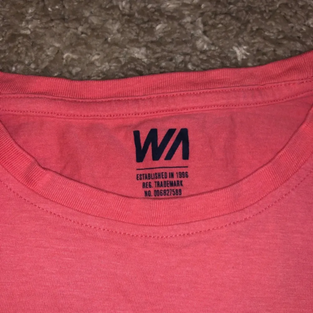 Coral red t-shirt with a navy pocket . T-shirts.