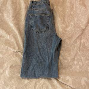 Never denim jeans strl W26 L32. Använt skick. Har hål längst ner vid fötterna.  Raka men skulle säga att de är mer åt baggy hållet.  
