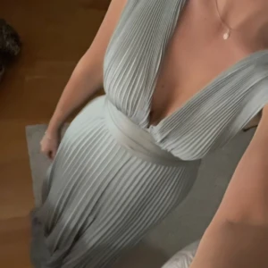 Balklänning - Plisserad balklänning i grågrön färg från ASOS tall i storlek 38, så den är väldigt lång men går förstås att sy upp. Helt oanvänd med prislapp kvar😍Köptes förra säsongen för 900kr