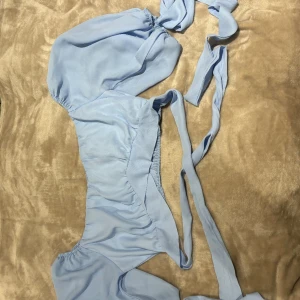 Topp - En ljusblå topp från shein som aldrig är använd då den inte passade mig. Den har fin snörning att knyta.