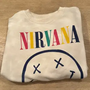 Det här är en Jättefin colagetröja med Nirvana tryck och med fina färger. Den är i bra skick och är nästan bara använd några fåtal gånger. Skulle verkligen rekommendera till ett par coola jeans!