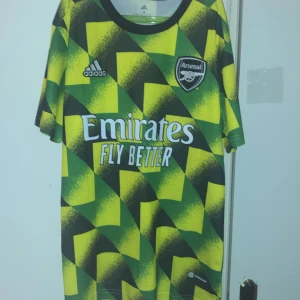Fotbollströja Arsenal pre match shirt - Säljer en riktig snygg arsenal tröja för lågt pris storlek S men passar M aldrig använd