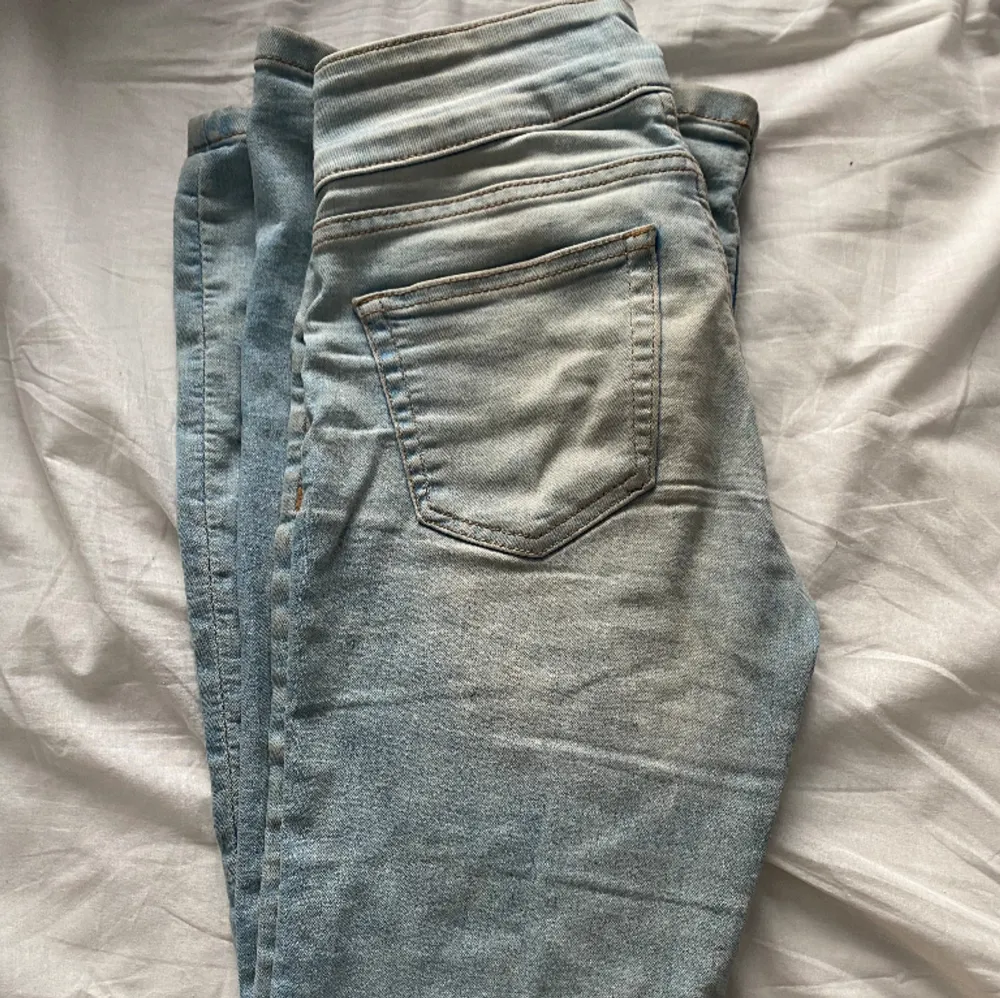 Supersnygga jeans med ett ”bälte” i midjan💋 ljusblå och flared. Som ni kan se på andra bilden är det små hål längst ner på benen men kan lätt lagas. Annars är dom faktiskt väldigt små så man tänker inte på det❤️älskarrr!! Köpppp. Jeans & Byxor.